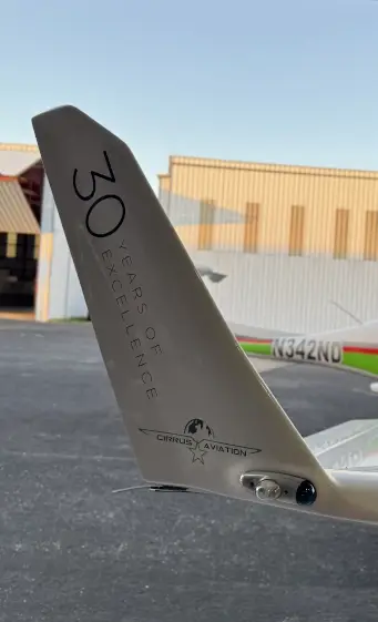 Aircraft's tail with Cirrus' logo and 30 years of excellence written on it