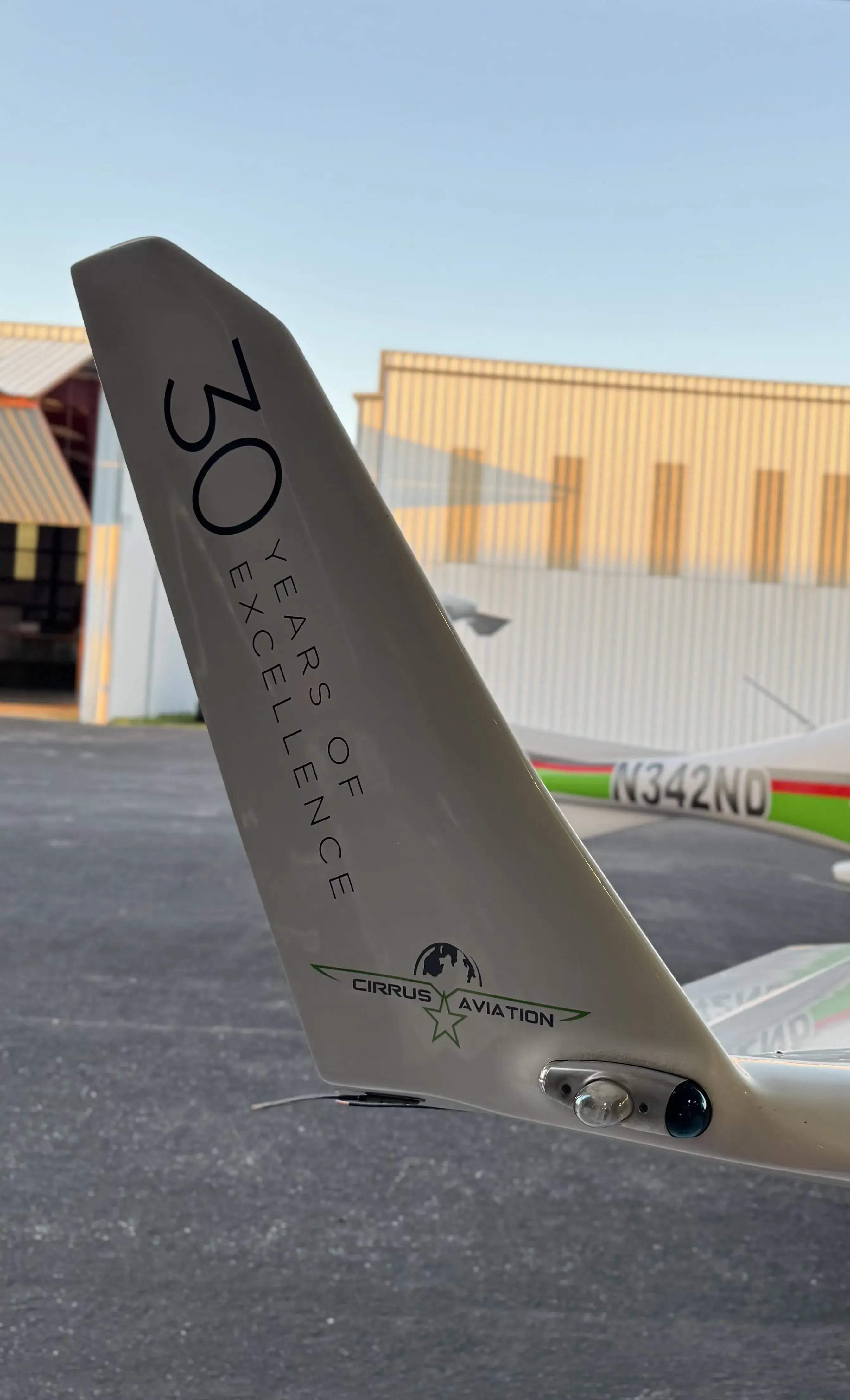 Aircraft's tail with Cirrus' logo and 30 years of excellence written on it