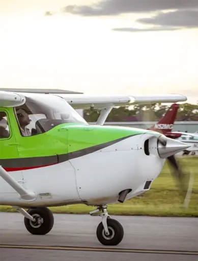 Plane taking off with sun in the background