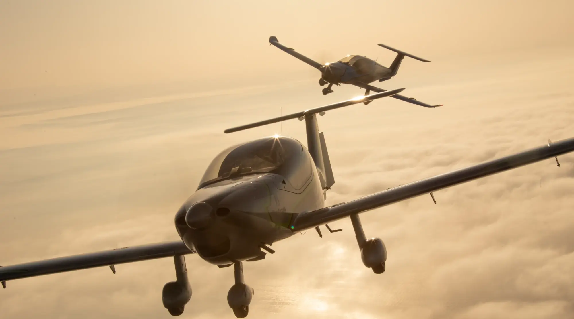 Two elixir aircraft flying above the clouds