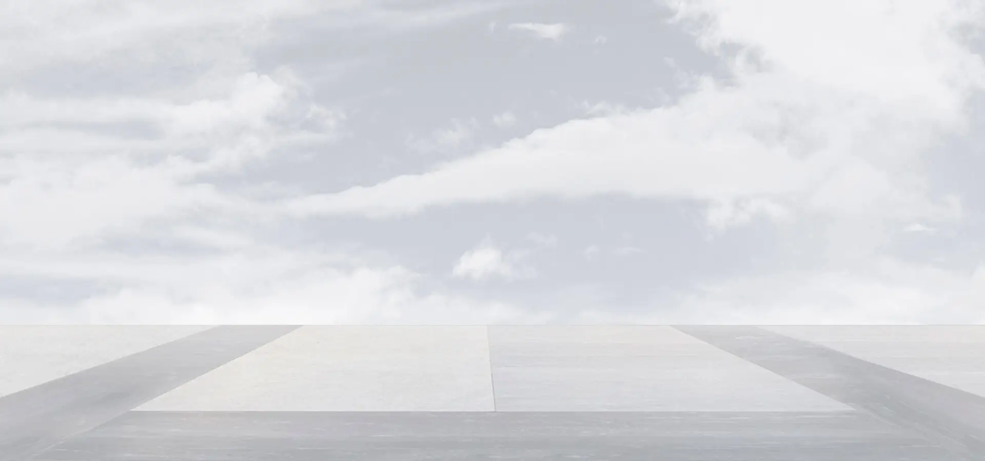 Bright gray background with runway at the bottom and clouds in the back