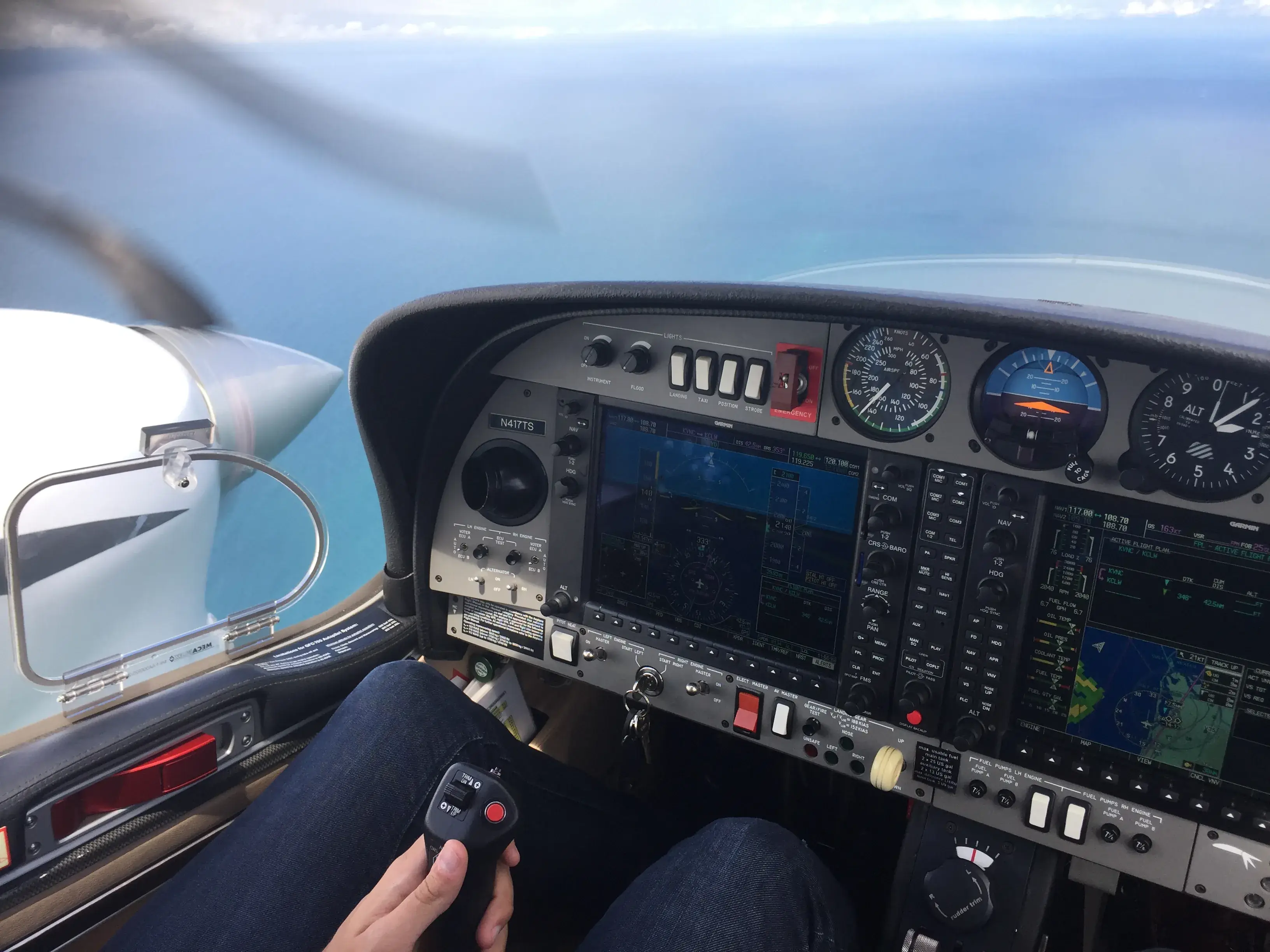 View from inside the cockpit of the instrument panel and the left turbine in a flying airplane