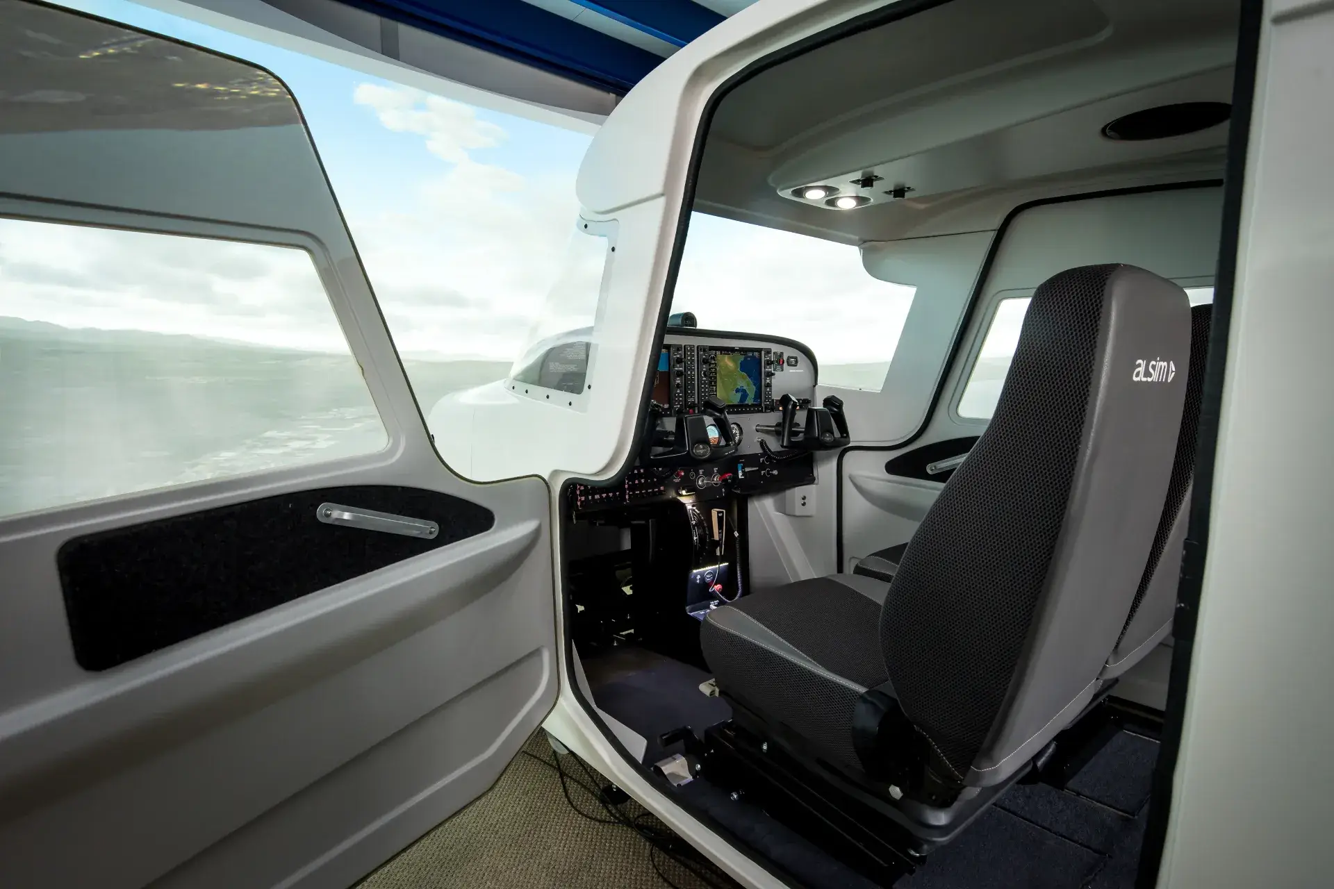 Flight simulator's cockpit seen from its open left door