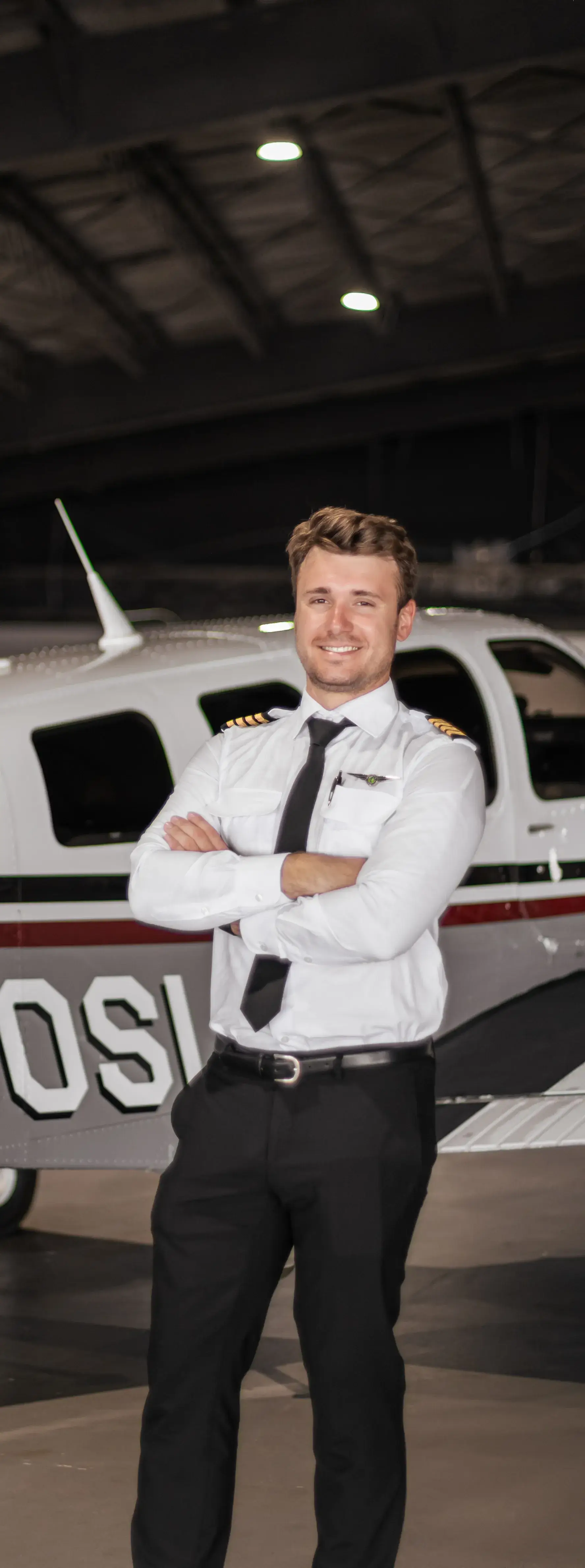 Full body photo of pilot smiling at the camera
