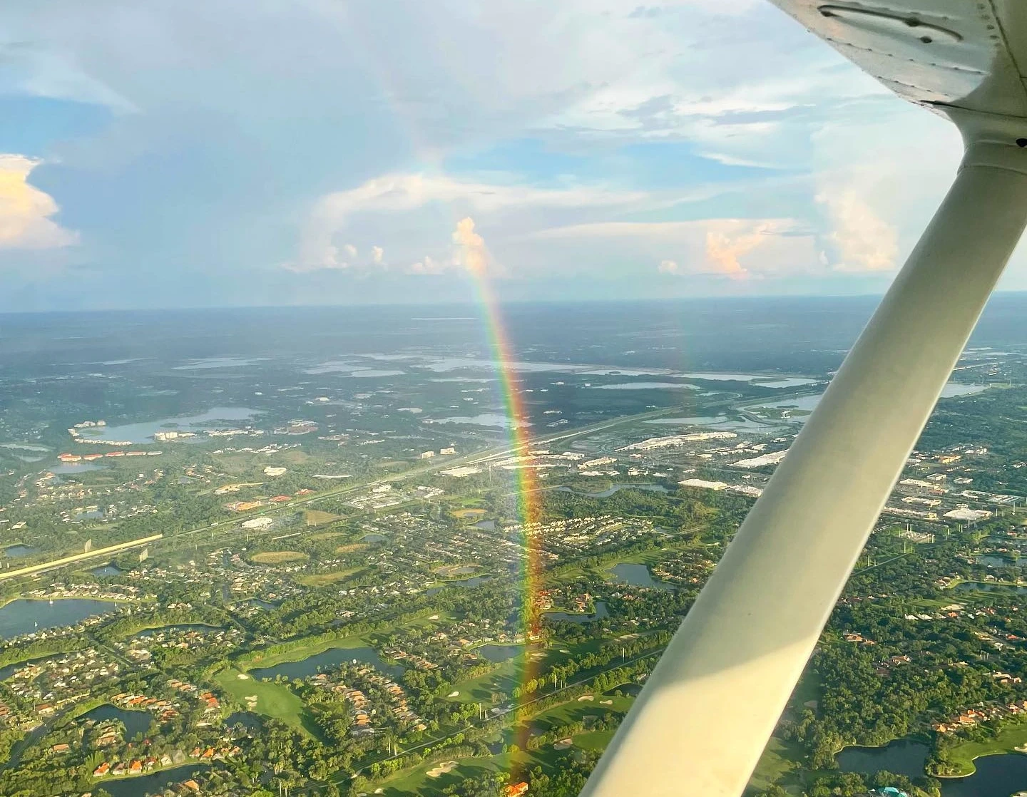 Rainbow seen from the window of a flying airplane