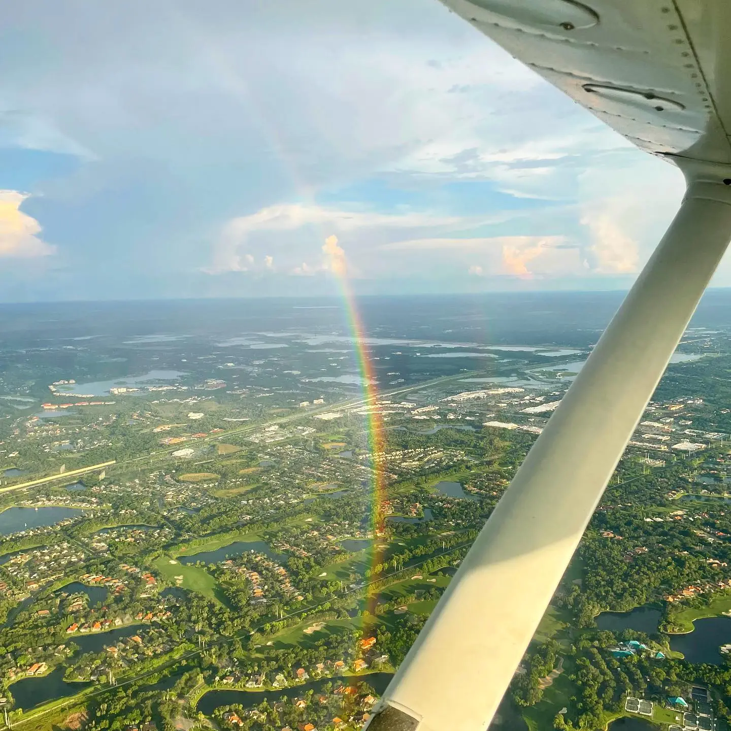 Rainbow seen from the window of a flying airplane