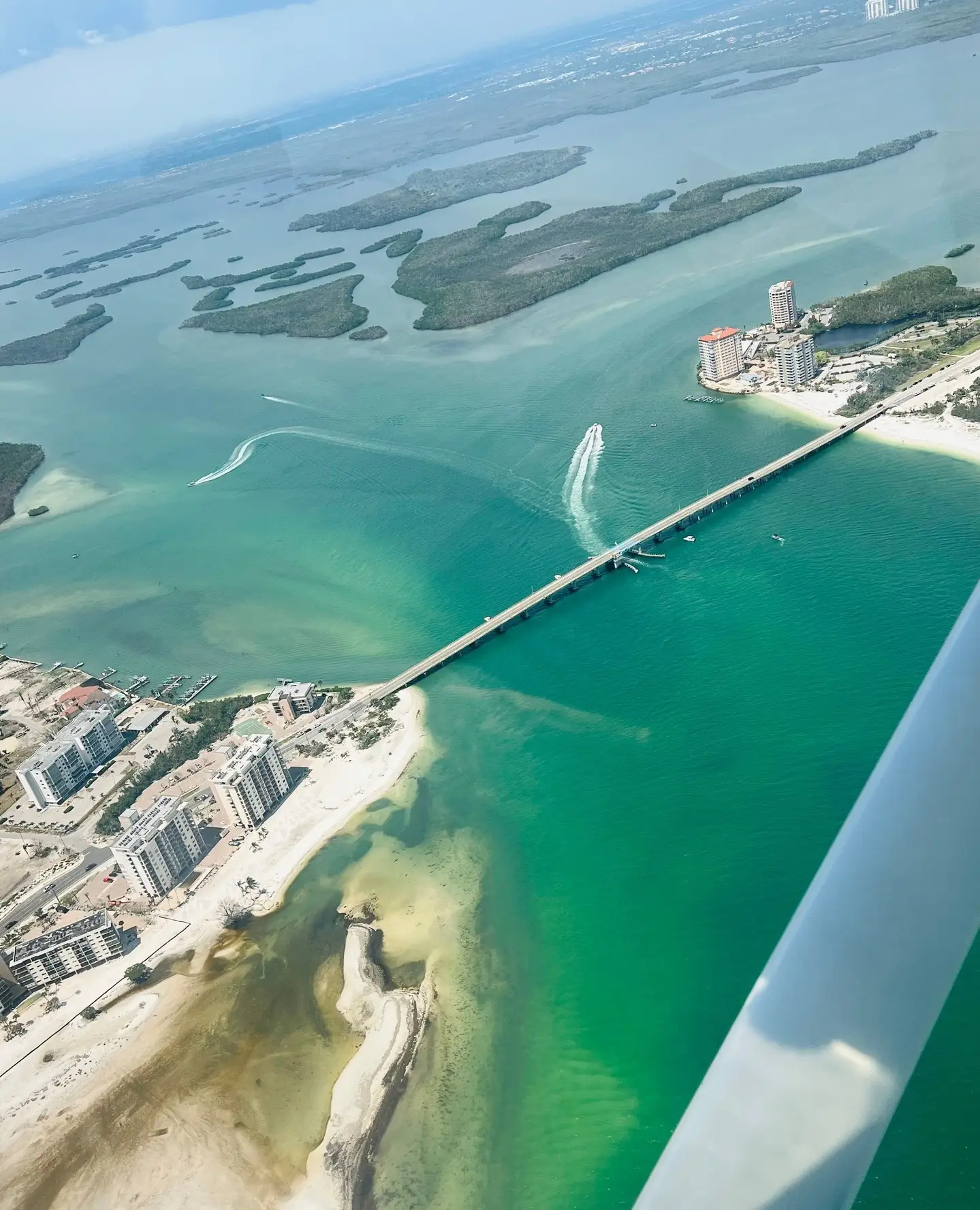 Sea and islands seen from above through an airplane window