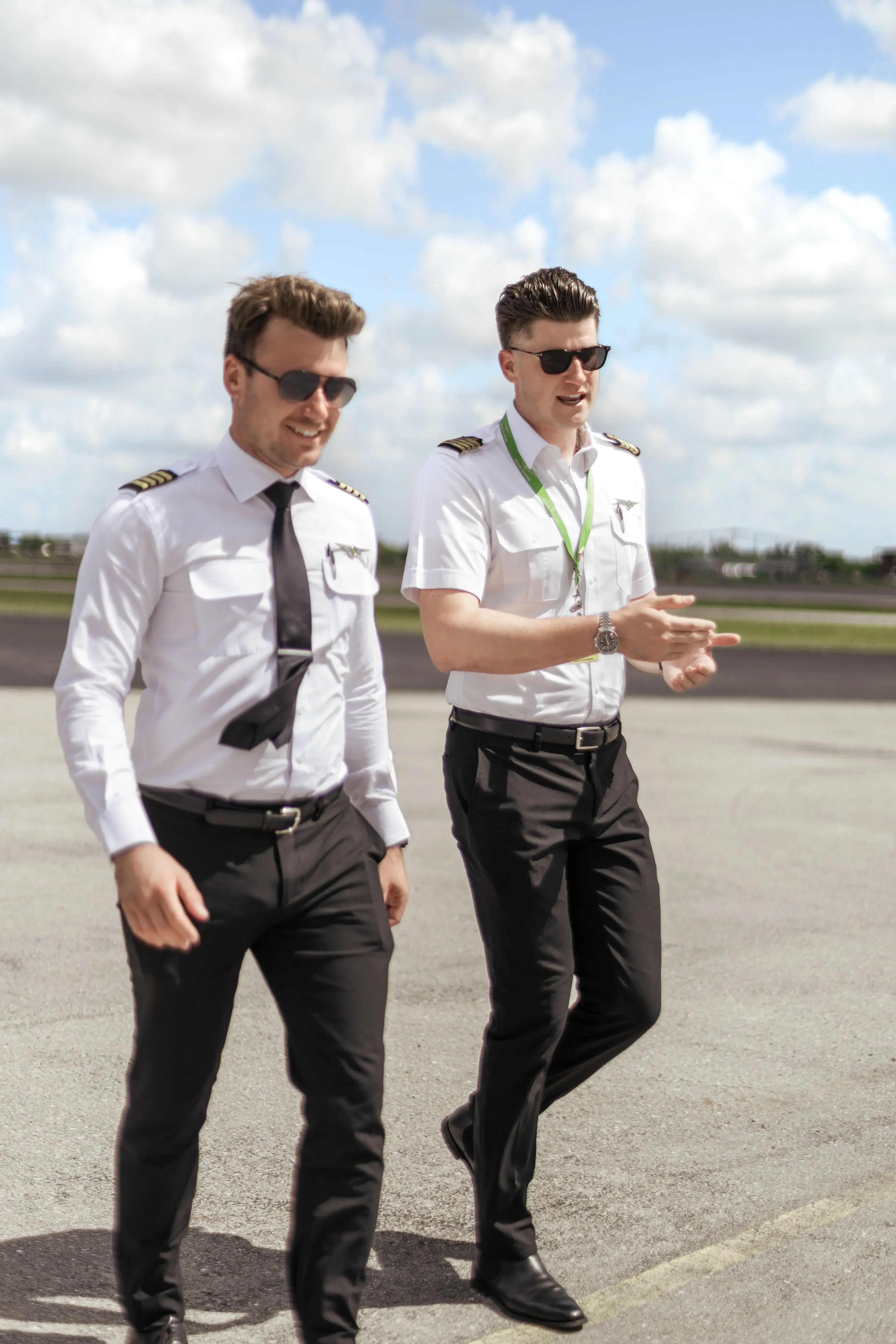 Two pilots walking on the runway