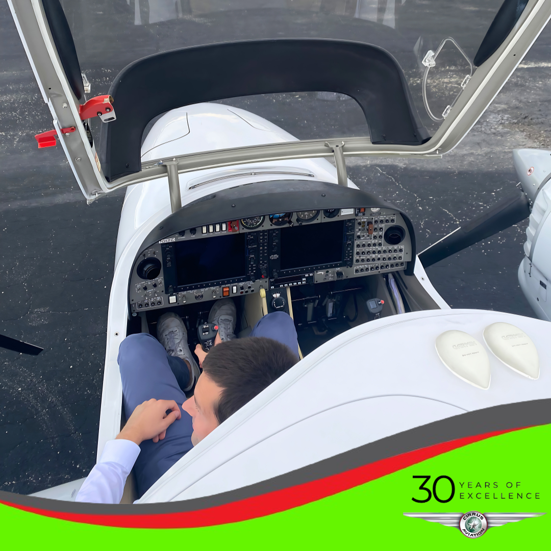 View from the top of the open cockpit of an aircraft with a person inside