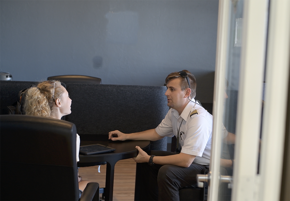 CFI making explanation to student over a table