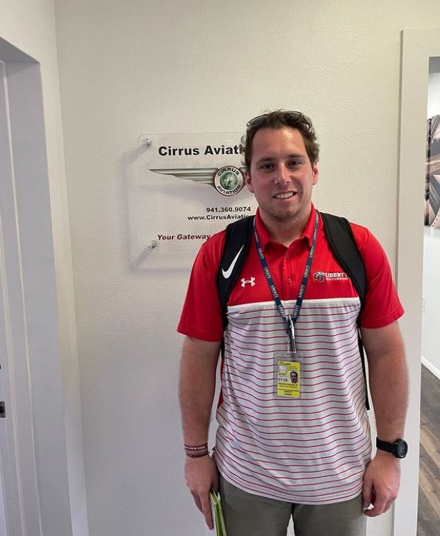 Student smiling at the camera inside Cirrus Aviation's office