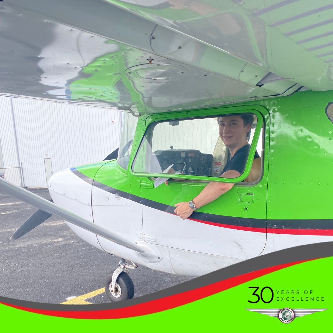 Student inside of a Cessna aircraft, Cirrus Aviation watermark at the bottom of the image