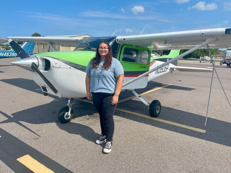 Student in front of a Cessna aircraft