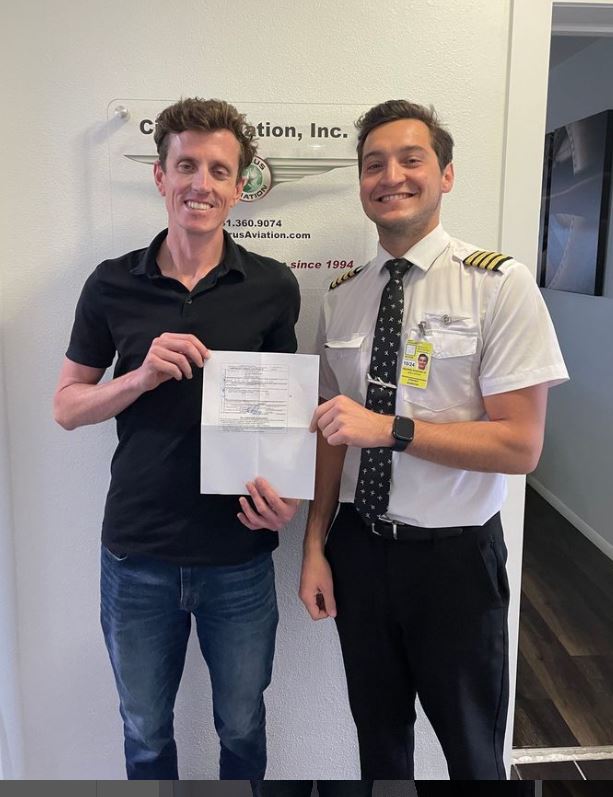 Student and CFI holding certificate and smiling to the camera