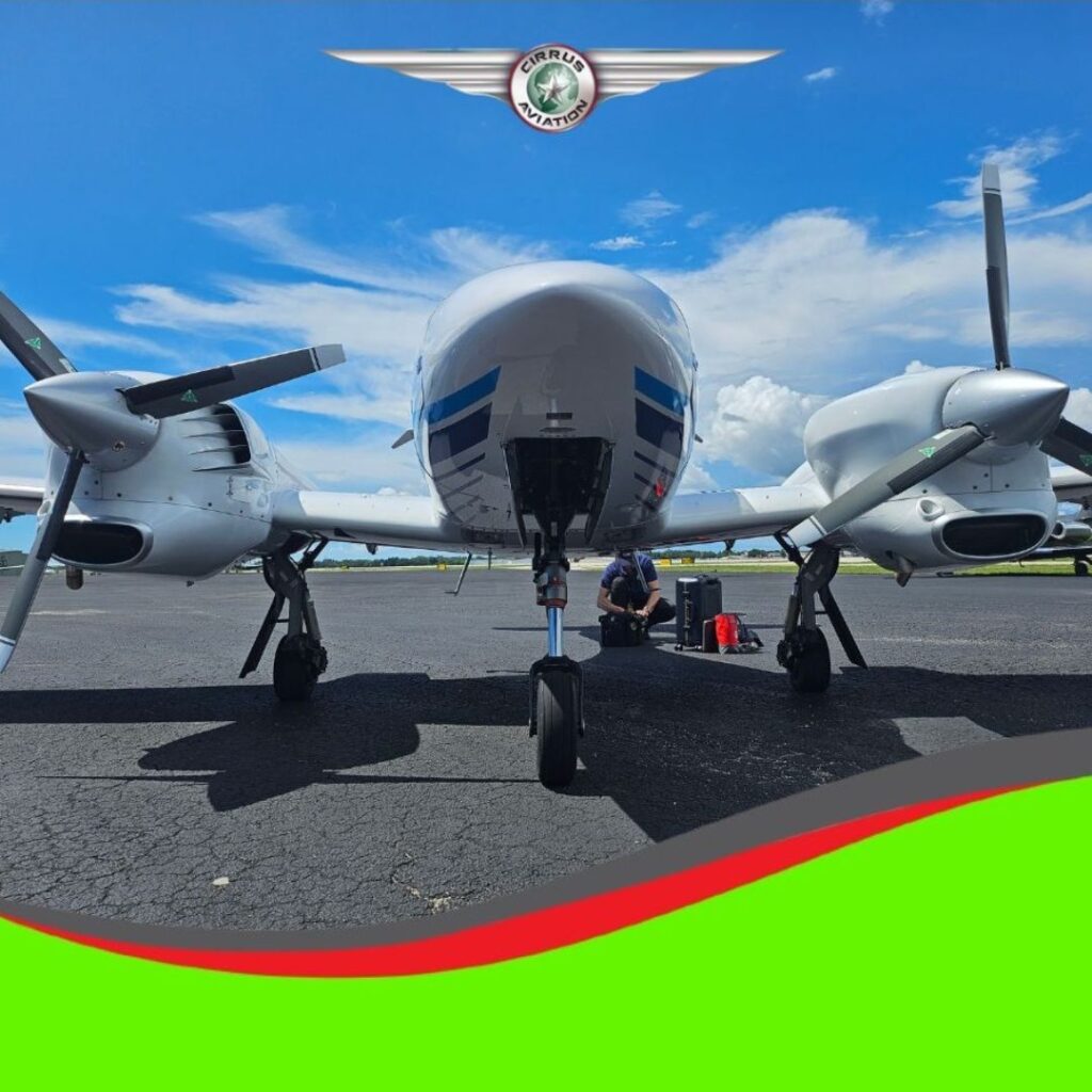 Diamond DA42 seen from the front, Cirrus Aviation watermark at the bottom