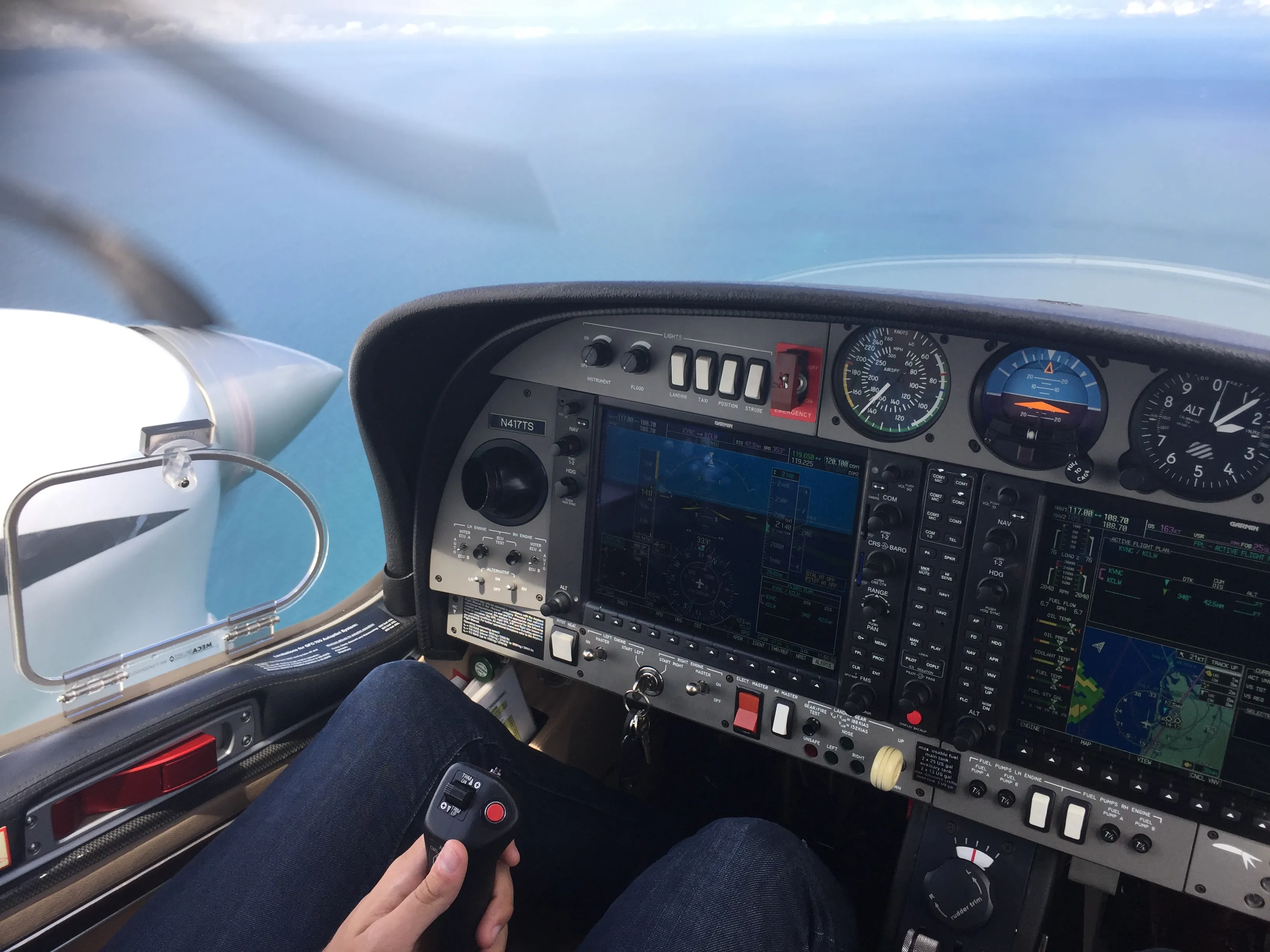 View from inside the cockpit of the instrument panel and the left turbine in a flying airplane